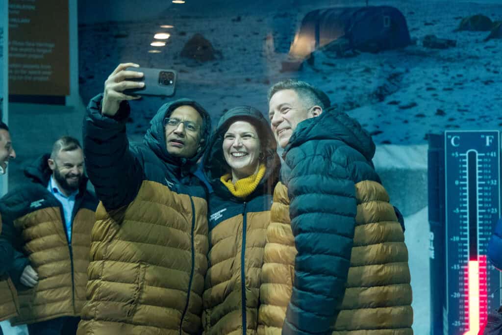 Group poses in chiller, at the International Antarctic Centre, Christchurch, New Zealand.