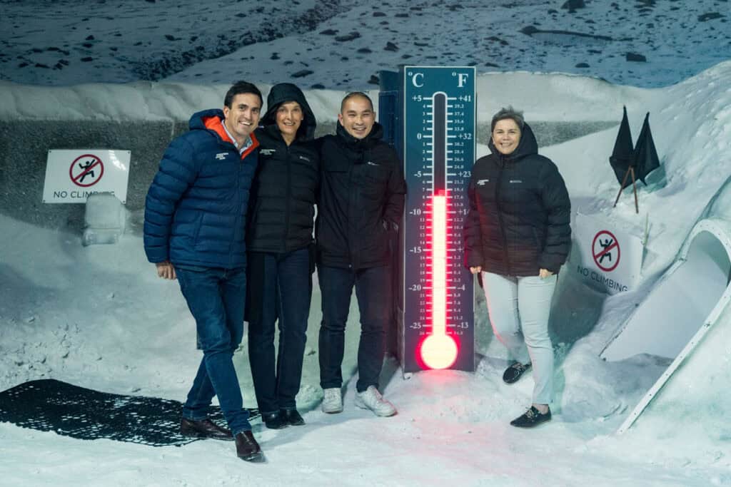 Event photography with group posed next to therometer at the International Antarctic Centre, Christchurch, New Zealand.