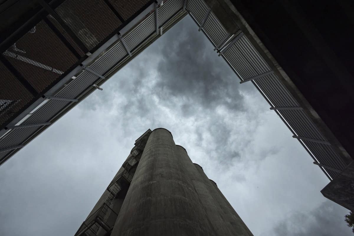 Looking up at old grain silos in warehouse district, Timaru.