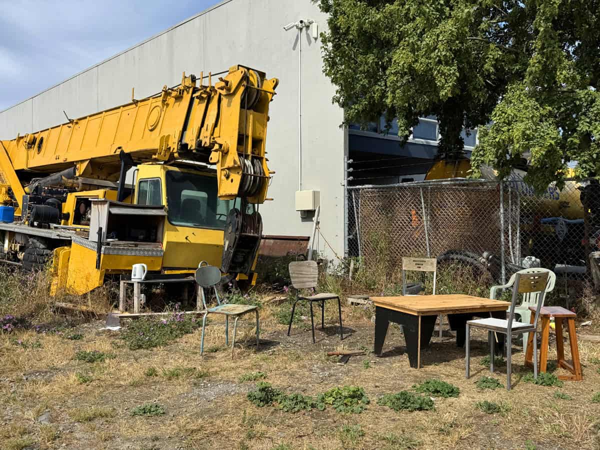 Workers smoko seats next to abandoned crane in an industrial area during Christmas holiday period.