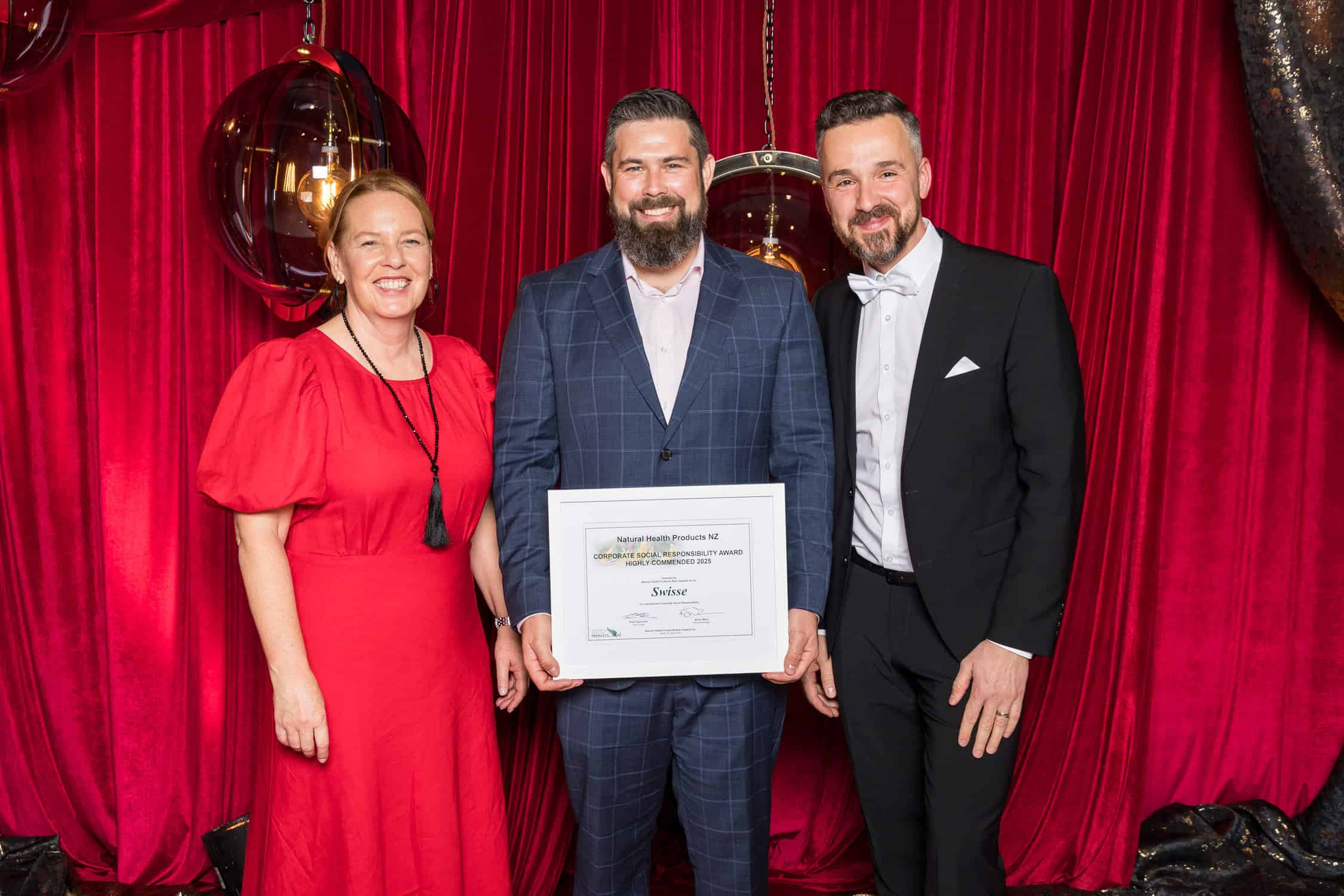 Winner of corporate category pose with sponsor and CEO.